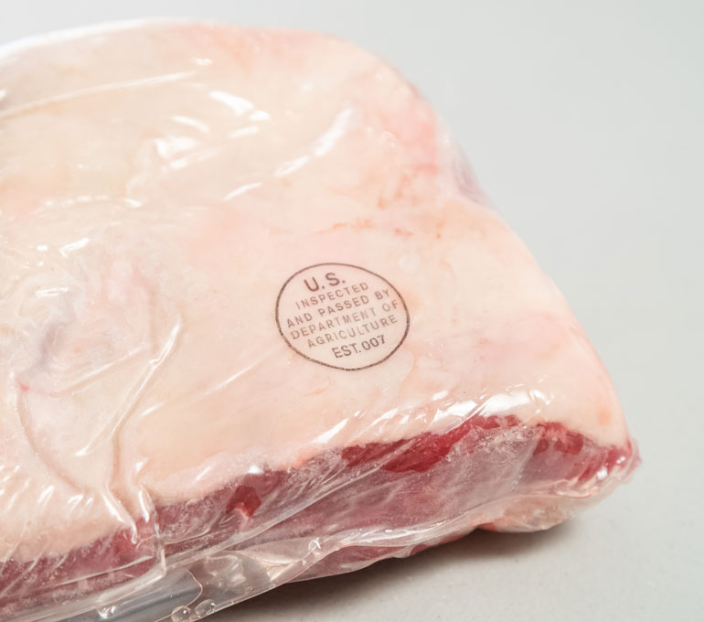 Plastic wrapped meat with inspection approved imprint