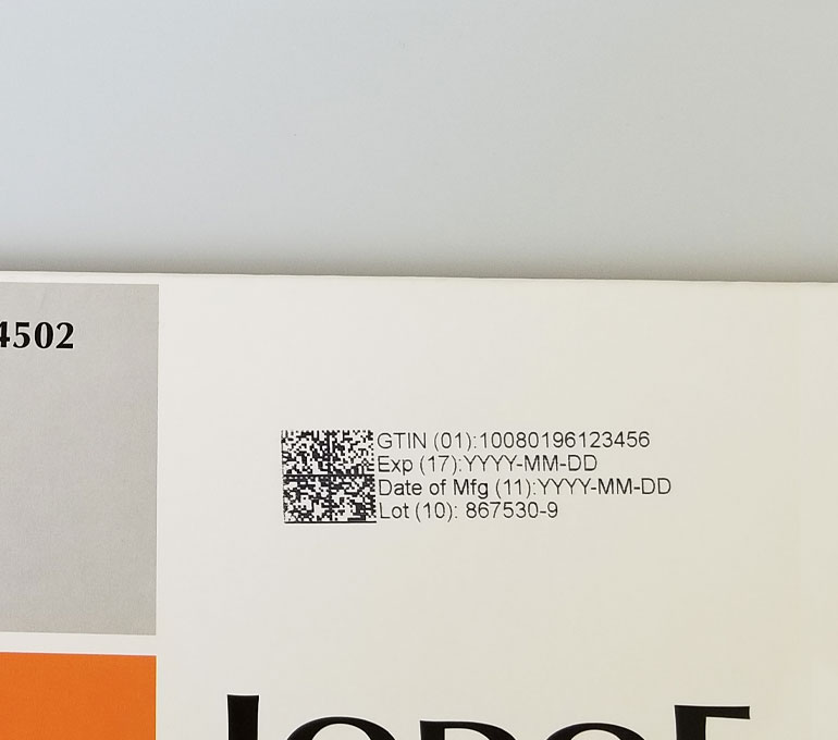 QR Code, Serial number, expiration date, and lot number on coated cardboard