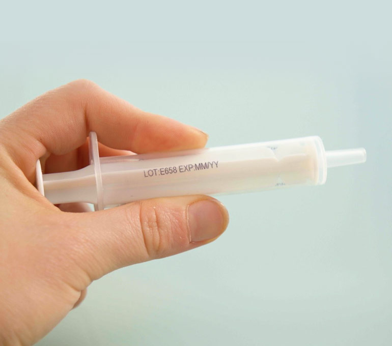 plastic syringe with lot number and expiration date