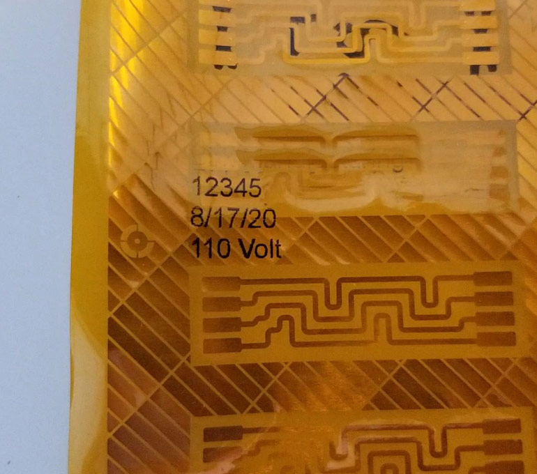 gold film with voltage, date, and part number