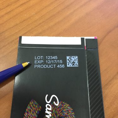 UDI 2D Data Matrix Print Example UDI 2D Data Matrix barcode print example, white ink on black glossy cardboard