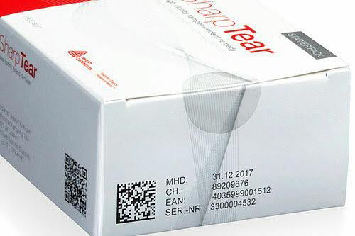 UDI 2D Data Matrix barcode print example, white ink on black glossy cardboard